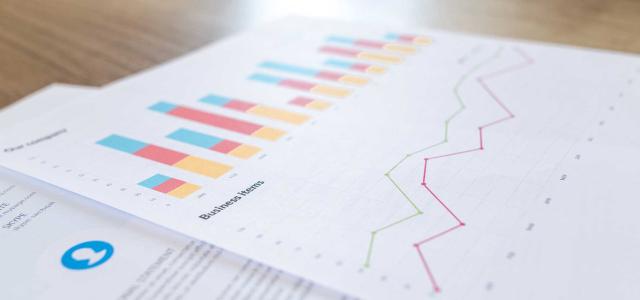 Charts and graphs on paper.